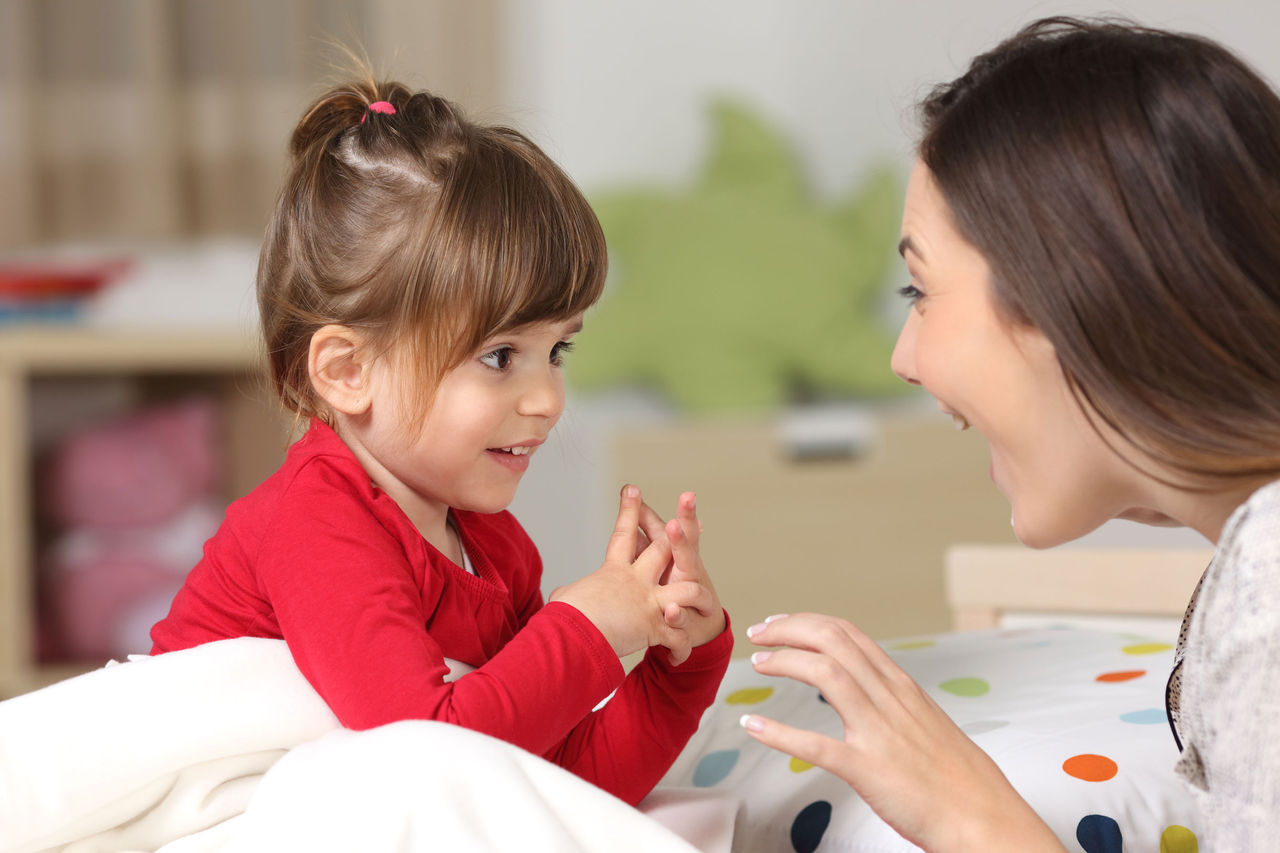 A mother and daughter looking at each other and smiling