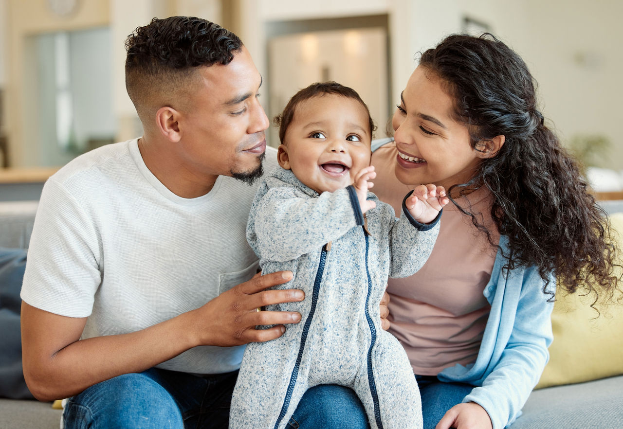 Mother and father holding a smiling baby